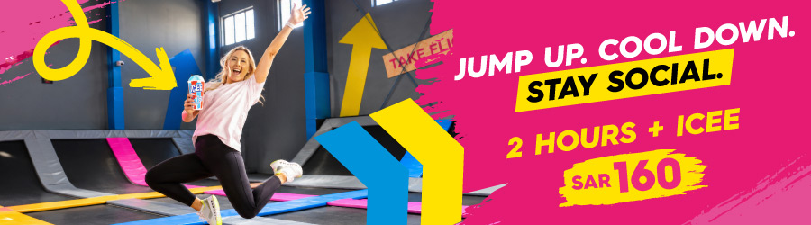 woman jumping on a bounce trampoline holding an ICEE